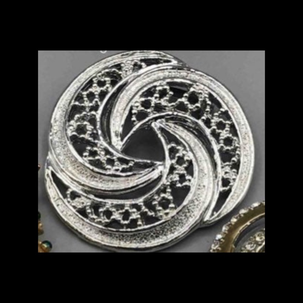 Gerry's signed silver tone pinwheel brooch